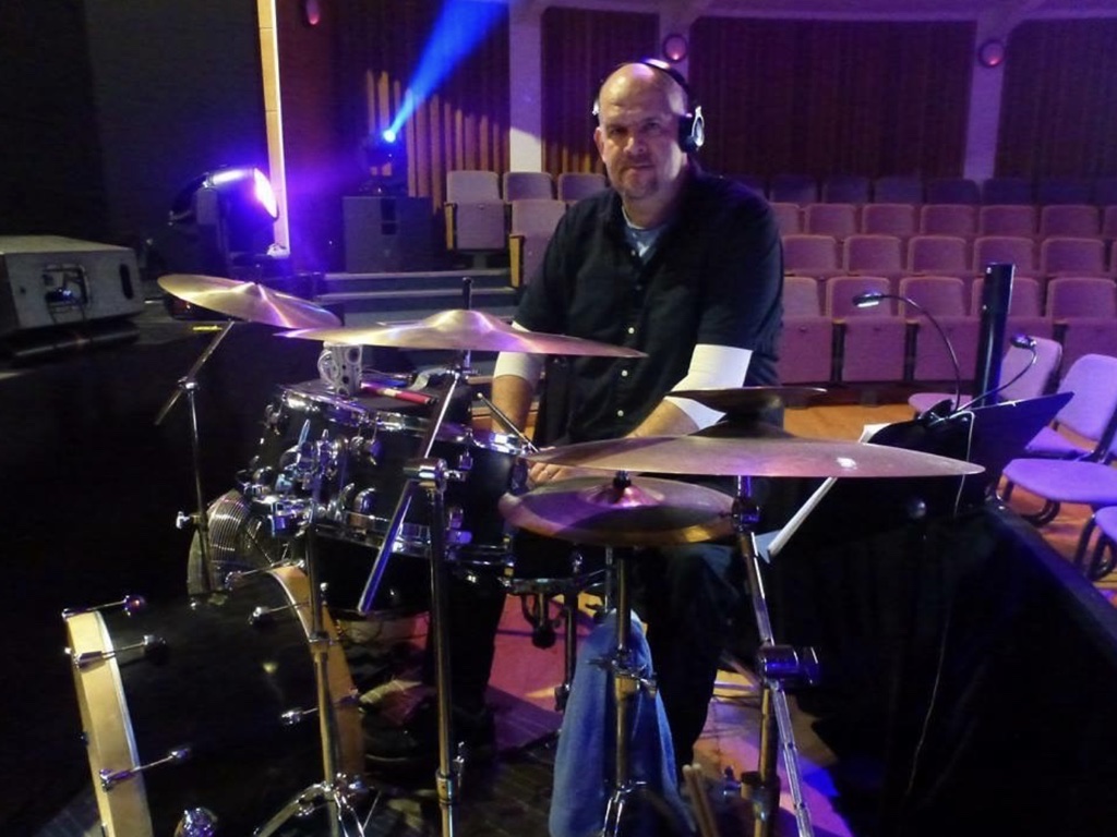 Ian Backhouse working at the drum kit in a theatre